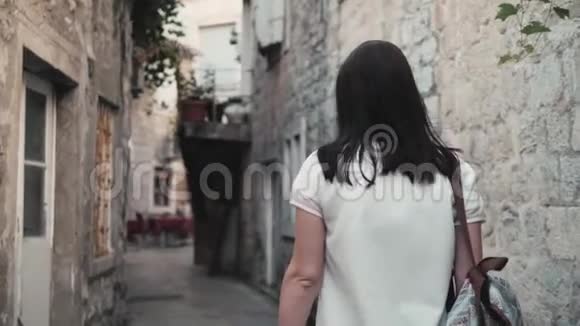 年轻女性在旧城街头漫步背包旅行时尚休闲的户外生活方式画像视频的预览图