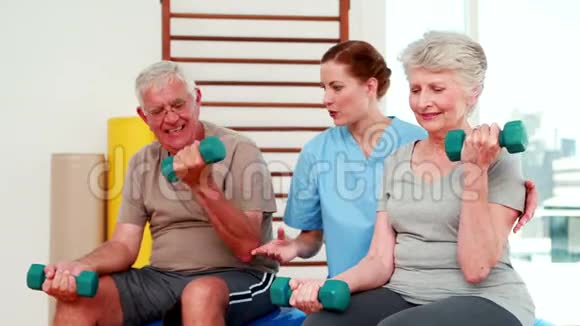 快乐的老年人与理疗师一起锻炼视频的预览图