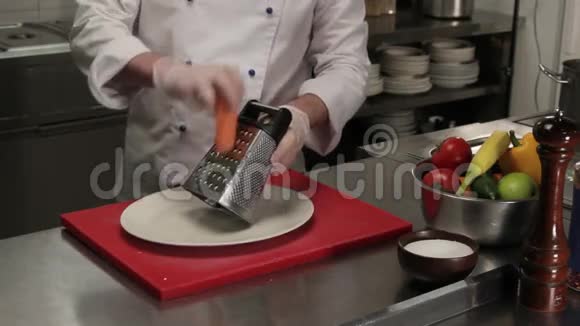 厨师用胡萝卜在磨盘上摩擦中档视频的预览图