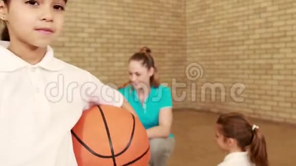 竖起大拇指拿着篮球的微笑女孩视频的预览图