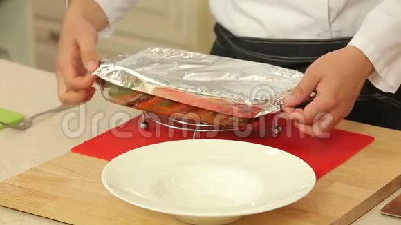 厨师正在盘子里端着刚烤好的拉塔多里菜视频的预览图