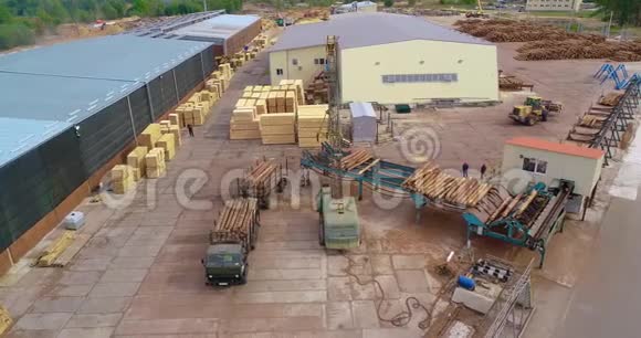 用起重机卸载原木车在锯木厂卸载原木在锯木厂从空中工作视频的预览图