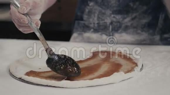 披萨烹饪工艺用硅胶糕点刷和番茄酱制作披萨基地木制背景俯视图视频的预览图