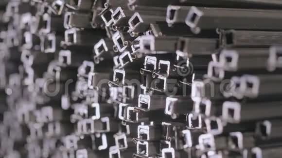 金属方形轮廓的抽象视图型材管道在有盖仓库内型材管道成排敷设在大型仓库内视频的预览图