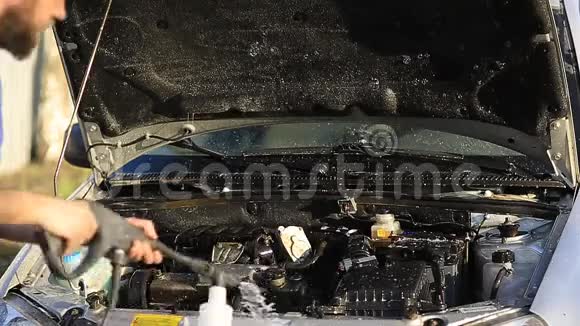 年轻迷人的男人用水灌满他的银色汽车视频的预览图