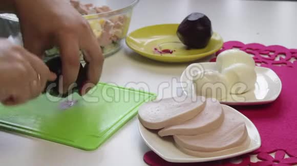 厨师把煮好的甜菜切在切割板上视频的预览图
