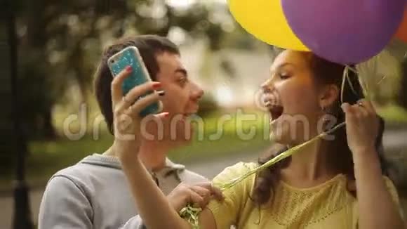 年轻夫妇在公园里用气球拍照视频的预览图
