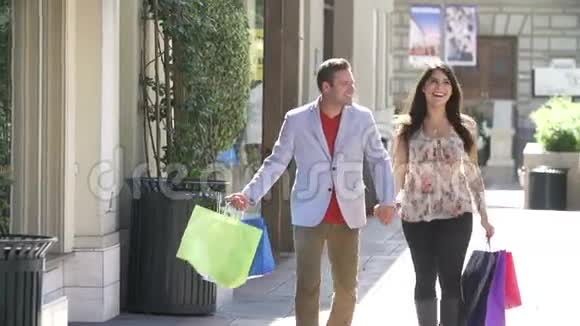 带包购物中心情侣购物的慢镜头视频的预览图