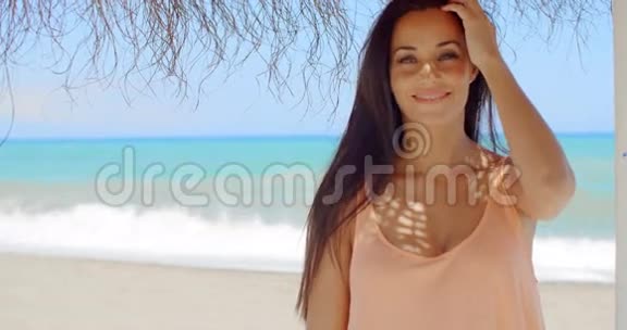 美丽的女士在海滩伞架上视频的预览图