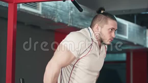 在健身房做二头肌锻炼的年轻壮汉视频的预览图