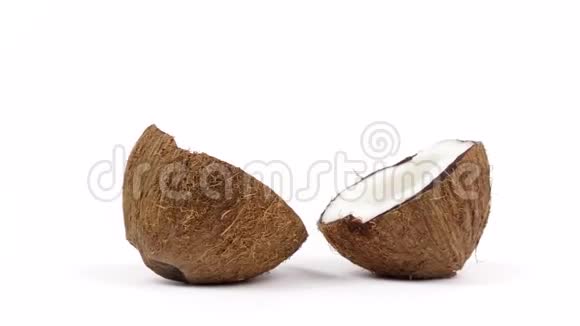 两个成熟的椰子半部分美味的果肉旋转在白色孤立的背景可循环无缝视频的预览图