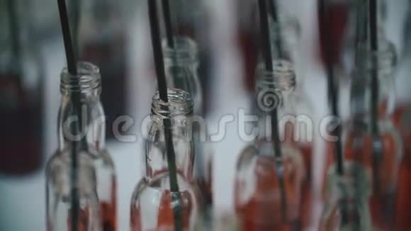 一组五颜六色的小瓶子酒精鸡尾酒白色桌子上的利口酒和鸡尾酒棒视频的预览图
