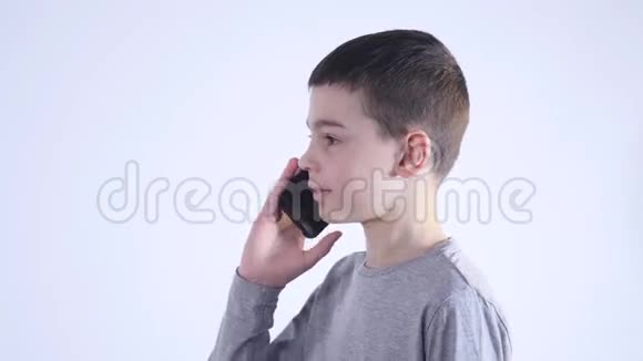一个在白色背景下打电话的小男孩视频的预览图