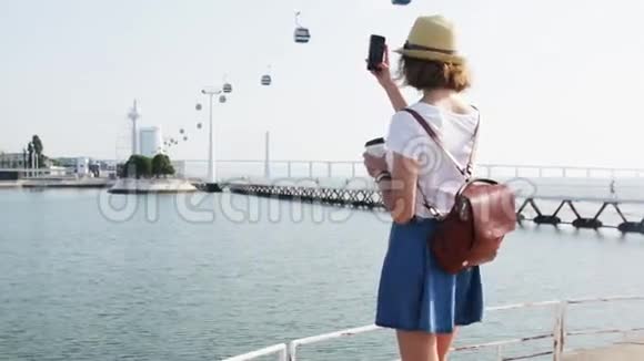 有魅力的年轻女子在塔古斯河附近的里斯本海洋馆拍照视频的预览图