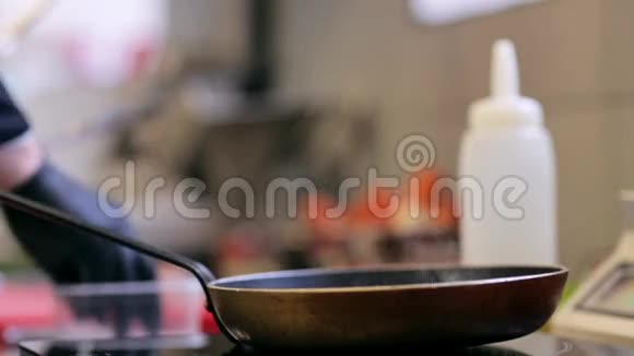 厨房用煎锅烹饪的厨师手视频的预览图