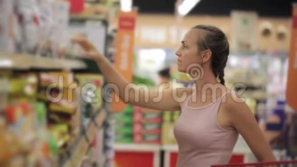 在超市糖果区选择零食的女人视频的预览图