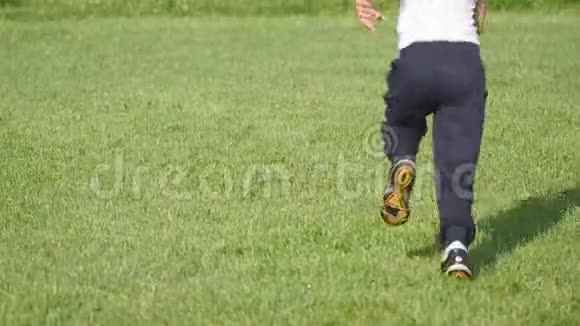 男孩在足球场上踢足球视频的预览图