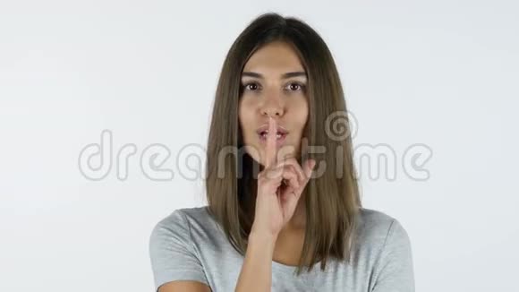 沉默的姿态美丽女孩的双唇手指工作室的白色背景视频的预览图