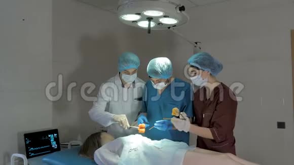 外科医生在工作复苏医疗队戴口罩手持医疗工具视频的预览图