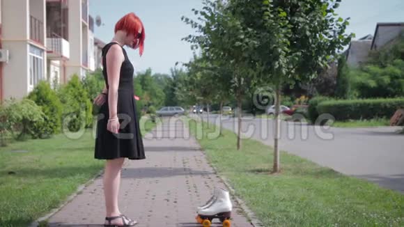 站在前面人行道上的红发女孩穿着黑色衣服视频的预览图