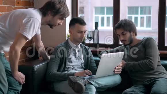 一群企业家在一间小办公室里一起工作和做笔记自由职业者会议带手提电脑的男人视频的预览图