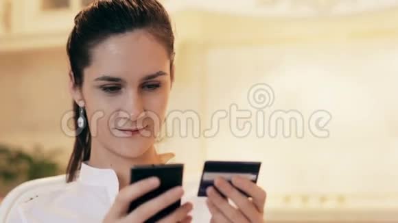 女人在家用手机网上购物视频的预览图