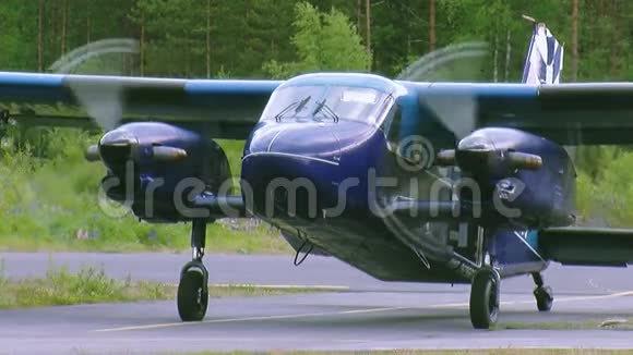 为跳伞者准备的蓝色飞机在绿色森林中空中起飞旋转螺旋桨航班视频的预览图