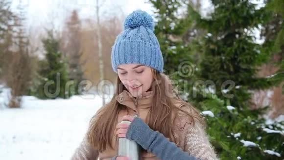 美丽的女孩在冬天喝热水视频的预览图