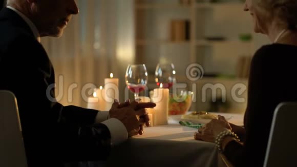 在餐厅的浪漫约会中老人和女人在聊天牵手视频的预览图