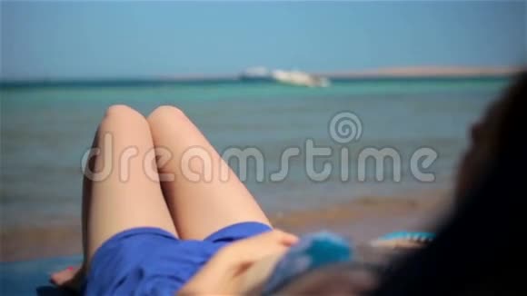 年轻纯洁的女孩子躺在海边穿着视频的预览图
