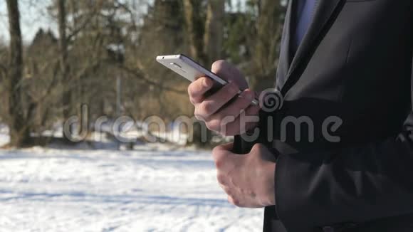 冬天在街上拿着智能手机的青少年视频的预览图