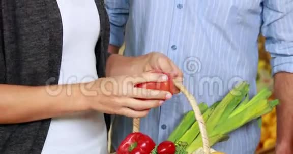 在杂货店里摘蔬菜的夫妇视频的预览图