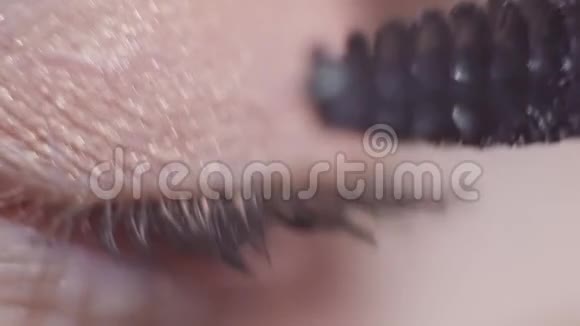 绿色眼模在睫毛膏上涂抹黑色化妆品视频的预览图