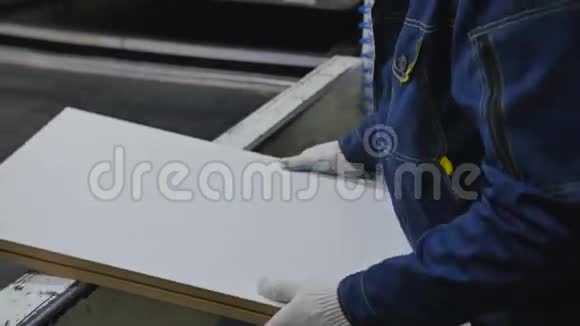 工人把胶合板放在压力机工作台上视频的预览图