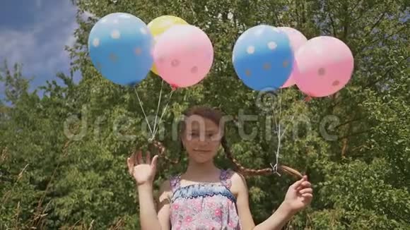 开朗漂亮的女孩她的头发上有五颜六色的球头上有辫子气球真有趣视频的预览图