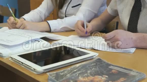 两个女学生坐在学校的书桌前视频的预览图