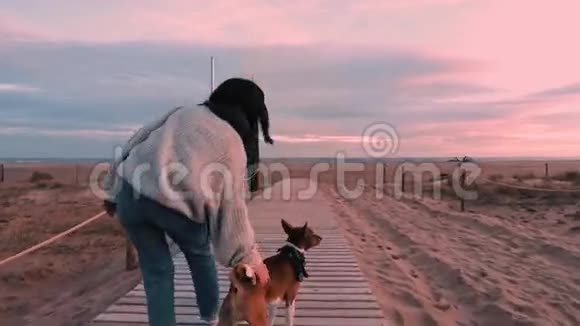 黎明时分美丽的黑发女孩走在海边视频的预览图