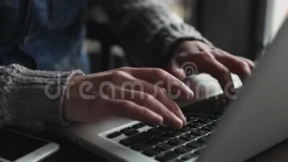 在键盘上输入白种人男性手的特写在室内使用笔记本电脑的人视频的预览图