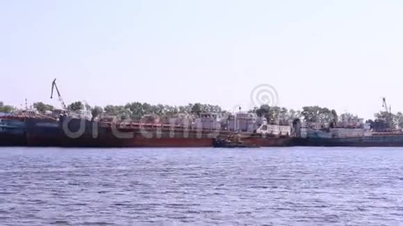船在最大的船只附近的河边漂浮视频的预览图