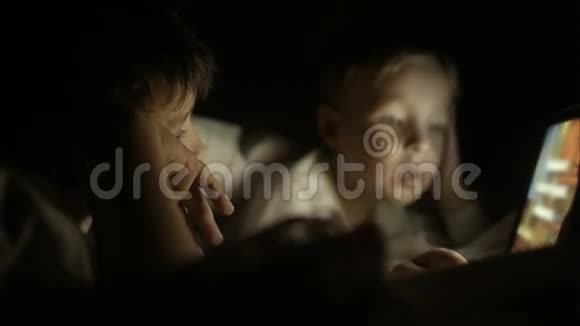 两个男孩晚上躺在床上用垫子视频的预览图