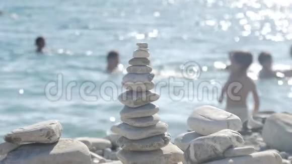 站在海边的一叠圆石平衡和谐的理念海洋海岸的岩石视频的预览图
