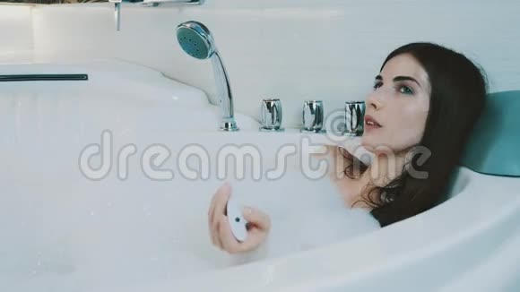 小女孩在浴室里洗了满是泡沫的澡通过控制器切换音乐视频的预览图