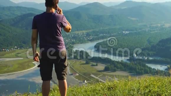 男人在山上用手机说话视频的预览图