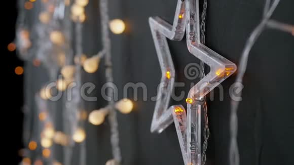 黑色墙壁背景上有灯光和星星的圣诞花环视频的预览图
