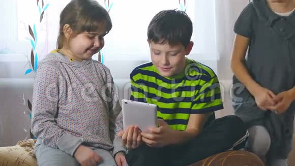 孩子们在平板电脑里玩两个女孩和一个男孩视频的预览图