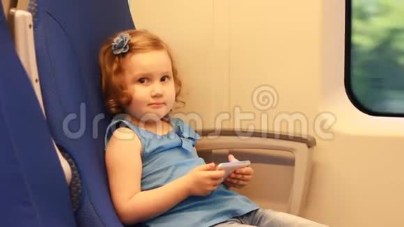 女孩在火车上玩智能手机视频的预览图