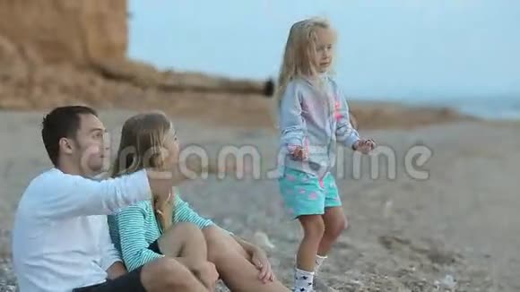 有父母的小女孩在海边放松视频的预览图