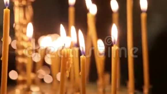 蜡烛在教堂的黑暗中燃烧黑色背景火焰视频的预览图