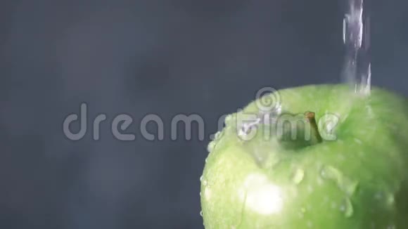 在美味的绿苹果上浇水慢动作视频的预览图