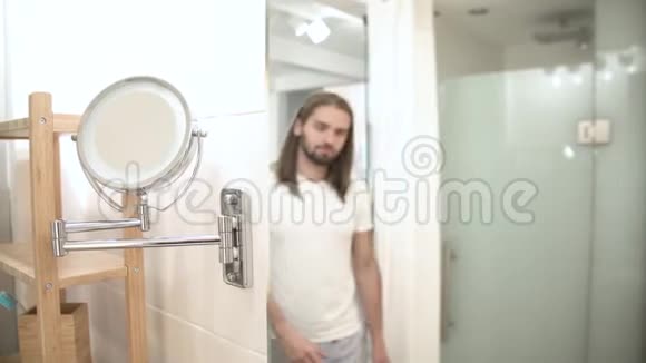 洗手间照镜子摸脸的男人视频的预览图